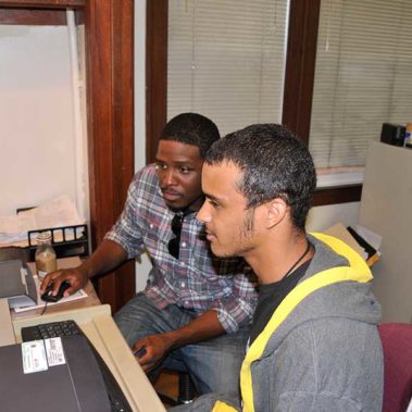 Randall showing client how to use a computer to search for a job